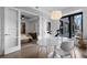 Dining area with marble table, chairs, and view into the bedroom, which contains a closet at 1750 Wewatta St # 700, Denver, CO 80202