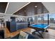 Inviting game room with a pool table, hardwood floors, a bar, and city views at 1750 Wewatta St # 700, Denver, CO 80202