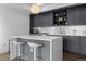 Modern kitchen with gray cabinetry, white countertops, and stainless steel appliances at 1750 Wewatta St # 700, Denver, CO 80202