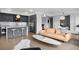 Open living area with gray kitchen, stainless appliances, and hardwood floors at 1750 Wewatta St # 700, Denver, CO 80202