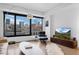 Stylish living room with expansive windows offering cityscape views, and contemporary decor and furnishings at 1750 Wewatta St # 700, Denver, CO 80202