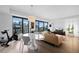 Open-concept living area with city views, modern furnishings, and hardwood flooring at 1750 Wewatta St # 700, Denver, CO 80202