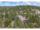 An aerial view of a charming home nestled among evergreen trees offers a private and serene setting at 2857 Hiwan Dr, Evergreen, CO 80439