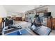 Well-lit basement with exercise equipment, wood paneling, and sliding glass doors at 2857 Hiwan Dr, Evergreen, CO 80439