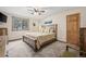 Bedroom with a wooden bed frame, plush carpeting, a ceiling fan, and a window with a view of trees at 2857 Hiwan Dr, Evergreen, CO 80439