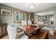 Dining room area showcasing a dining table, bench, armchairs and a china cabinet in a naturally lit space at 2857 Hiwan Dr, Evergreen, CO 80439