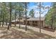 Charming home with stone accents, nestled among mature trees on a well maintained lawn at 2857 Hiwan Dr, Evergreen, CO 80439