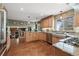 Gourmet kitchen with custom cabinets, granite countertops, stainless steel appliances, and hardwood floors at 2857 Hiwan Dr, Evergreen, CO 80439