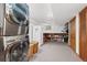 Laundry room featuring modern machines, a refrigerator, storage, and tile flooring at 2857 Hiwan Dr, Evergreen, CO 80439