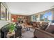 Cozy living room with a stone fireplace, exposed wood beams, and comfortable seating area at 2857 Hiwan Dr, Evergreen, CO 80439