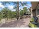 Outdoor patio area with comfortable seating and stone accents, surrounded by nature at 2857 Hiwan Dr, Evergreen, CO 80439