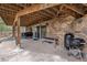 Covered patio featuring stone accents and outdoor seating, offering a relaxing space at 2857 Hiwan Dr, Evergreen, CO 80439