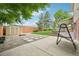 Backyard view with a hammock, fire pit, shed, and a well-maintained lawn, creating an inviting outdoor space at 6320 E Asbury Ave, Denver, CO 80224