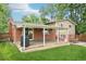 This backyard features a covered patio, a grill, a hammock and lush green grass at 6320 E Asbury Ave, Denver, CO 80224