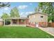 The backyard features a covered patio, a hammock, and a well-maintained lawn at 6320 E Asbury Ave, Denver, CO 80224