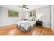 Bright bedroom with wood floors, two windows, and ample natural light at 6320 E Asbury Ave, Denver, CO 80224