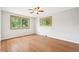 Bright empty bedroom with hardwood floors, large windows, and ceiling fan at 6320 E Asbury Ave, Denver, CO 80224
