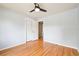 This bedroom features hardwood floors, a ceiling fan, and a closet at 6320 E Asbury Ave, Denver, CO 80224