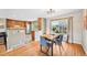 Dining room with natural light, hardwood floors, and seamless flow to the kitchen at 6320 E Asbury Ave, Denver, CO 80224