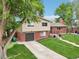 Beautiful two-story home featuring a brick facade, attached garage, and lush green lawn at 6320 E Asbury Ave, Denver, CO 80224