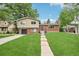 Inviting front exterior showcasing a well-maintained lawn, brick details, and a tidy landscape at 6320 E Asbury Ave, Denver, CO 80224