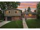 Charming brick home with a well-manicured lawn and colorful sunset backdrop at 6320 E Asbury Ave, Denver, CO 80224