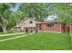 Attractive home with a brick and siding exterior, complemented by a green lawn at 6320 E Asbury Ave, Denver, CO 80224