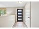 Bright foyer featuring a modern front door, tile floors, and neutral wall color at 6320 E Asbury Ave, Denver, CO 80224