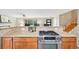 Updated kitchen with granite counters, stone backsplash, and stainless gas range at 6320 E Asbury Ave, Denver, CO 80224