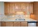Kitchen featuring granite countertops, stainless dishwasher, and maple cabinetry at 6320 E Asbury Ave, Denver, CO 80224