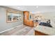 Galley kitchen boasts stone countertops, stainless steel appliances, and breakfast bar at 6320 E Asbury Ave, Denver, CO 80224