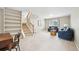 Comfortable living room featuring neutral walls, carpet, staircase, and windows at 6320 E Asbury Ave, Denver, CO 80224