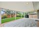 Inviting covered patio with outdoor string lights, a grill, and views of the backyard at 6320 E Asbury Ave, Denver, CO 80224