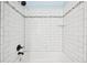 The renovated shower showcases new tile, updated fixtures, and a clean modern design at 6320 E Asbury Ave, Denver, CO 80224