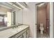 Bathroom featuring a sink, vanity, and toilet behind an open door at 8164 Flower Cir, Arvada, CO 80005