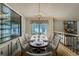Elegant dining room featuring a chandelier, a large window, and stylish seating for formal gatherings and meals at 8164 Flower Cir, Arvada, CO 80005