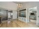 Dining room with hardwood floors, elegant chandelier, and display cabinet at 8164 Flower Cir, Arvada, CO 80005
