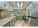 Updated kitchen with stone countertops and stainless-steel appliances at 8164 Flower Cir, Arvada, CO 80005
