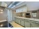 Bright kitchen with a breakfast bar, stainless steel appliances, and stylish cabinets at 8164 Flower Cir, Arvada, CO 80005