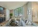 Bright living room with a brick fireplace, a large window, and stylish furnishings, creating a comfortable space at 8164 Flower Cir, Arvada, CO 80005