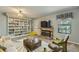 Cozy living room with a fireplace, built-in shelving, and comfortable seating, perfect for relaxing and entertaining guests at 8164 Flower Cir, Arvada, CO 80005
