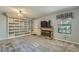 Spacious living room with fireplace, built in shelving, and lots of natural light at 8164 Flower Cir, Arvada, CO 80005