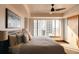 Cozy bedroom featuring a king-size bed, city view, and a ceiling fan at 1133 14Th St # 1820, Denver, CO 80202