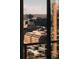 View of a vibrant cityscape, showcasing a mix of mid-rise and high-rise buildings, seen through a window at 1133 14Th St # 1820, Denver, CO 80202