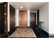 Hallway with dark wood trim, a neutral rug, and multiple doors, along with a bicycle at 1133 14Th St # 1820, Denver, CO 80202