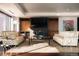 Bright living room featuring hardwood floors, modern sofas, and a fireplace with a large flatscreen TV at 1133 14Th St # 1820, Denver, CO 80202