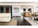 Modern living space with sleek dark wood floors, neutral furnishings, and an open floor plan flowing into the kitchen at 1133 14Th St # 1820, Denver, CO 80202