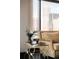 Living room detail showcasing modern tables, stylish furniture, and a stunning city view through a large window at 1133 14Th St # 1820, Denver, CO 80202