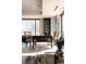 Bright office space with cityscape view, a sleek dark wood desk, and built-in shelving for storage at 1133 14Th St # 1820, Denver, CO 80202
