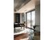 Bright office space with cityscape view, a sleek dark wood desk, and built-in shelving at 1133 14Th St # 1820, Denver, CO 80202